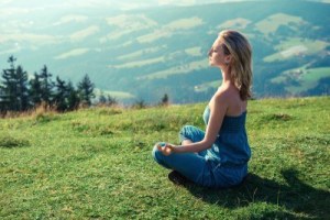 15026877-young-woman-meditating-outdoors